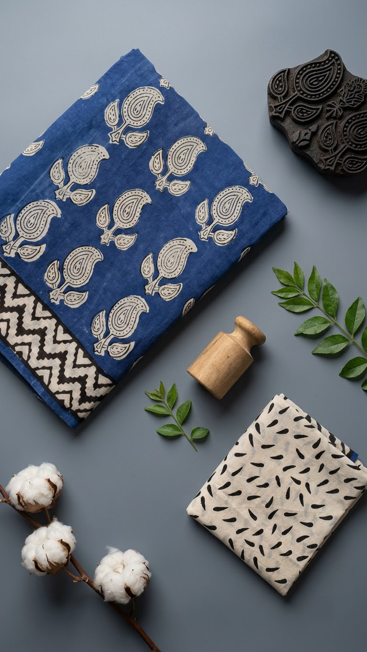 Close view of royal blue paisley cotton saree with zigzag border and ivory leaf-print blouse piece