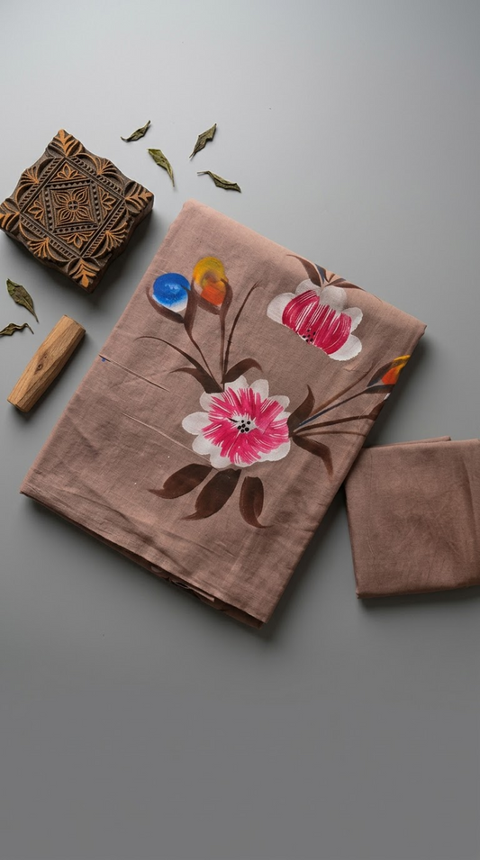 Dusty rose floral cotton saree with pink-and-ivory blossoms and its plain matching blouse piece in a styled flat lay