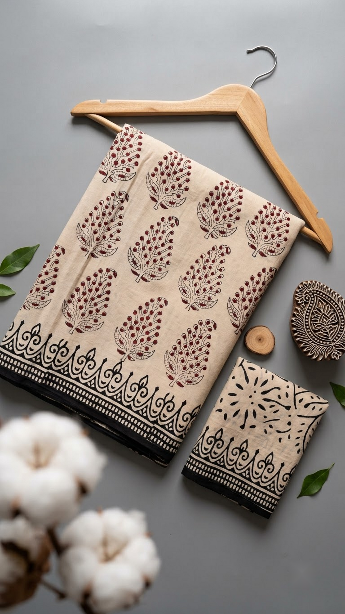 Ivory botanical sprig cotton saree with its black twig-print blouse piece in a styled flat lay