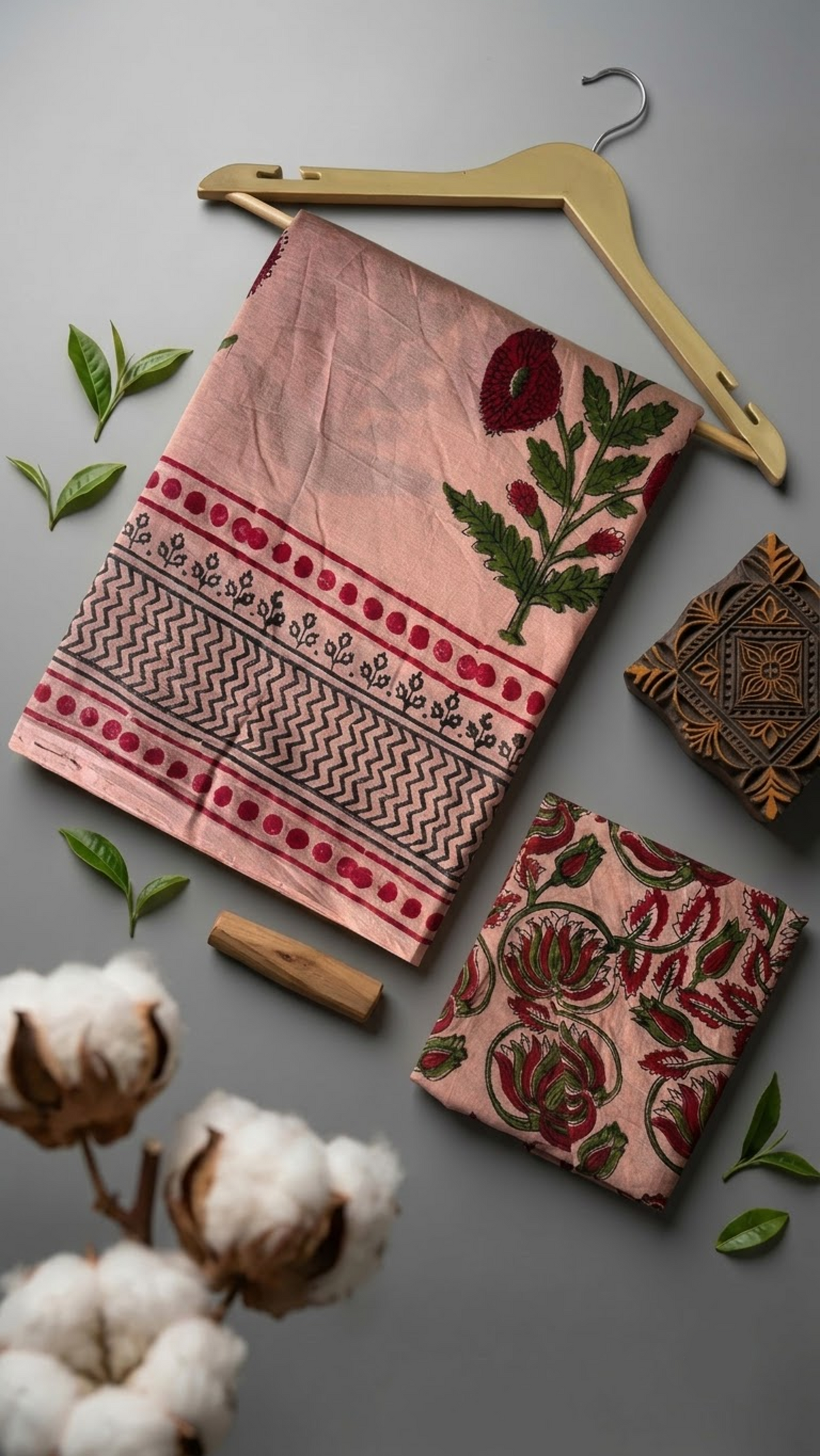 Peach pink botanical cotton saree with its floral blouse piece in a styled flat lay