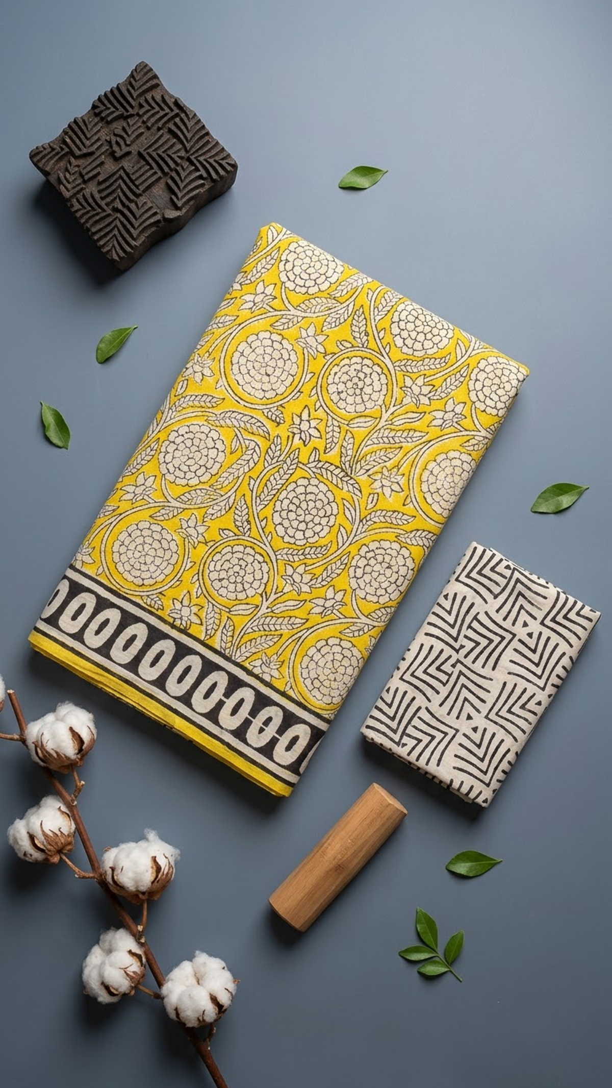 Closer artisan arrangement of the yellow floral-vine cotton saree, black oval-loop border, yellow edge and cream blouse with black angular line prints
