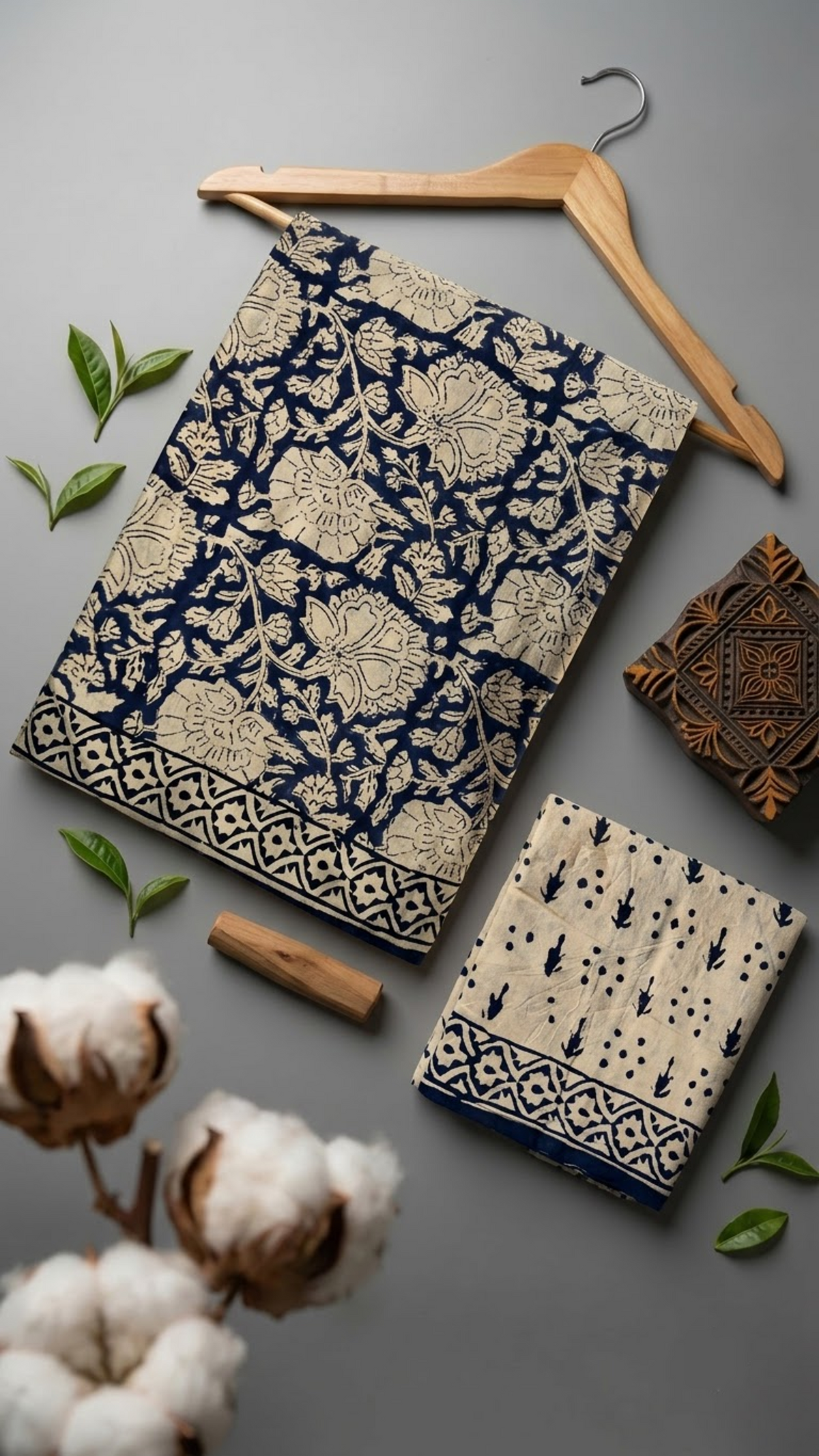 Flat lay of dark floral vine cotton saree with coordinating blouse piece