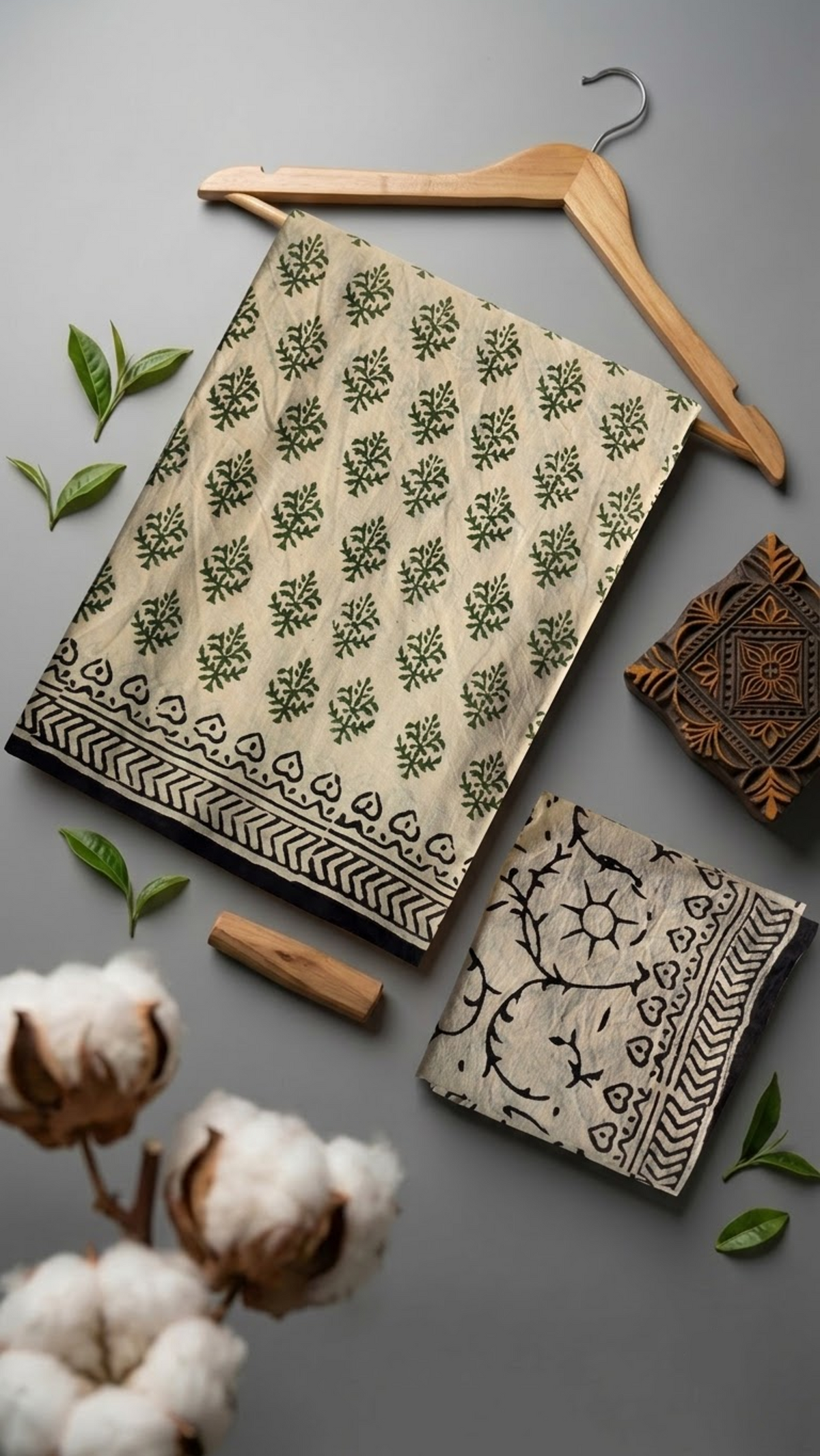 Flat lay of ivory green botanical cotton saree with coordinating blouse piece