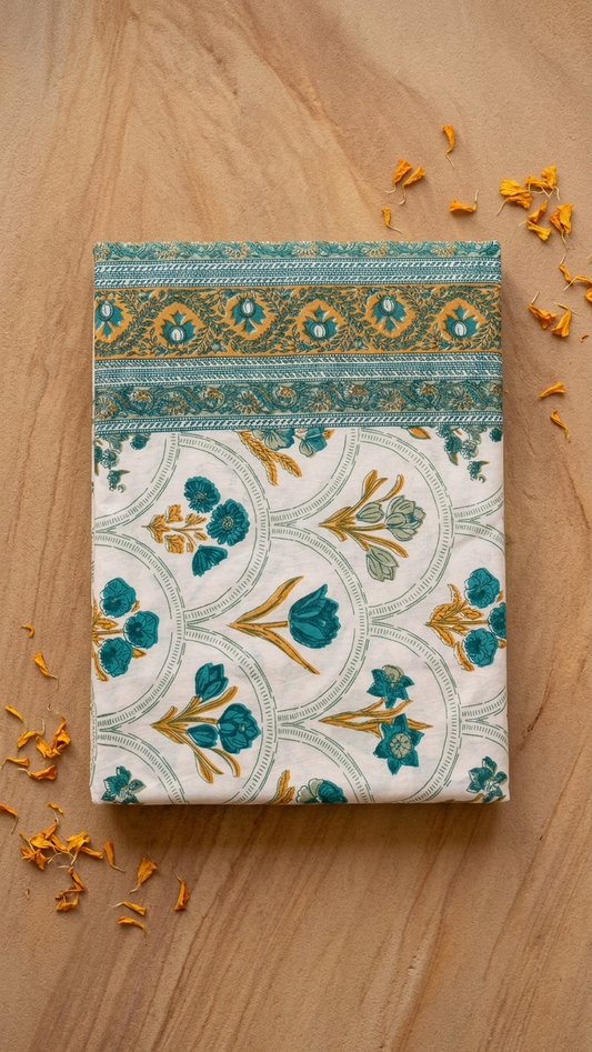Teal Blossom & Gold Trellis Block Print Cotton Bedsheet Set folded, showing arched floral trellis motif and border